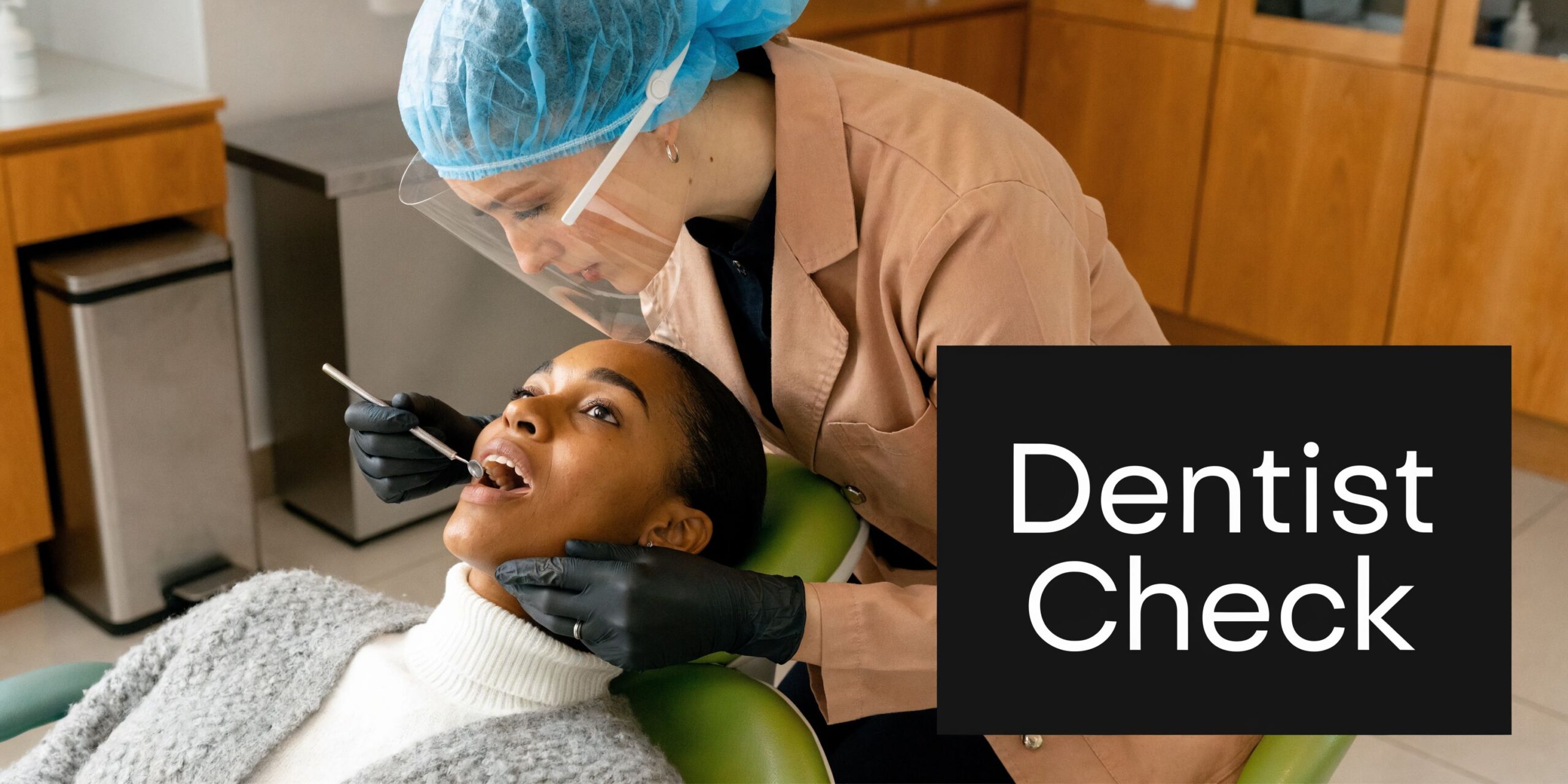 A professional dentist performing a routine oral examination on a female patient in a modern dental office.